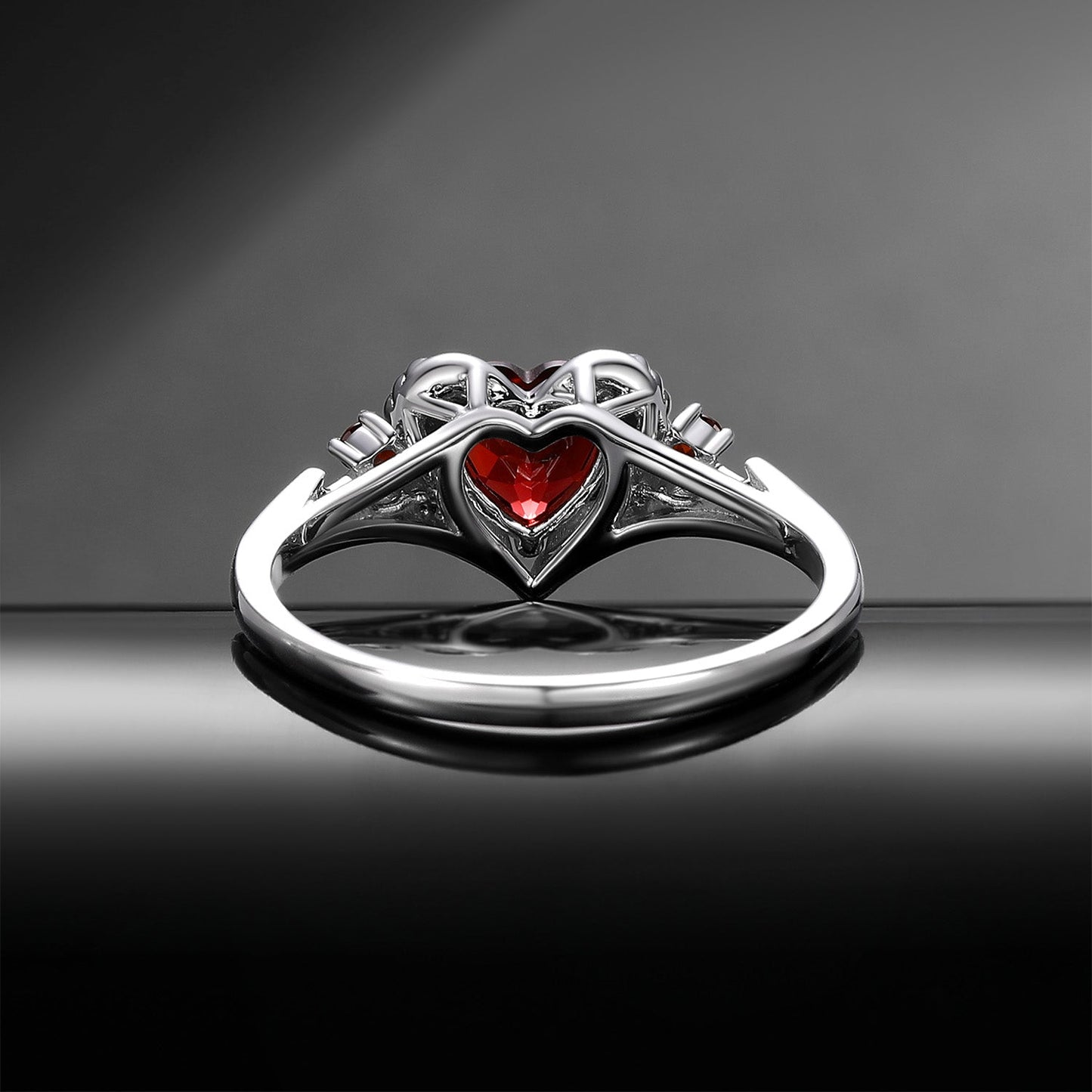 Heart & Sword 'Pierced Heart' – Gothic Garnet Engagement Ring with Angel Wing Detail