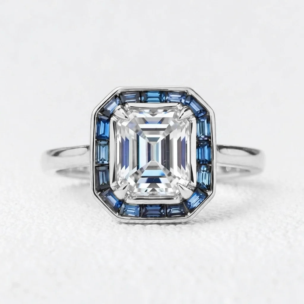 Celia’s Ode | 1CT Emerald Cut Diamond Engagement Ring with Sapphire Halo