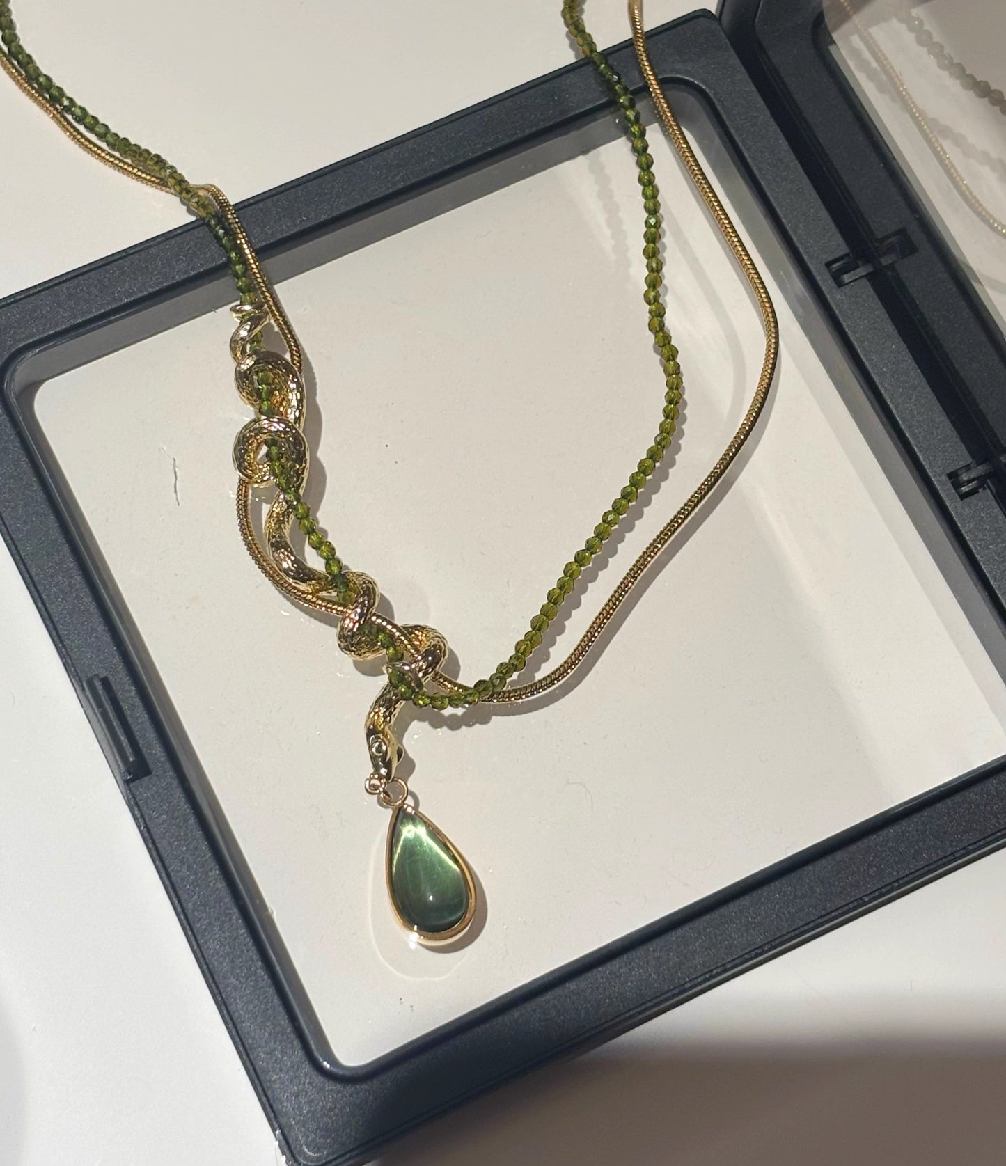 Thalia- Pear Cut Green Peridot Unique Serpent Shape Necklace