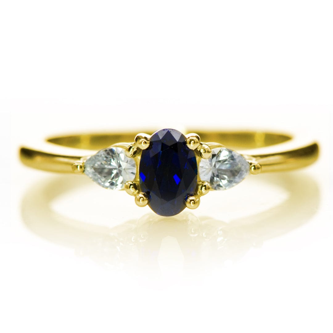 Tressa - Three Stone Prong Set Oval Lab Sapphire Engagement Ring with Pear-shaped White Sapphire Accents