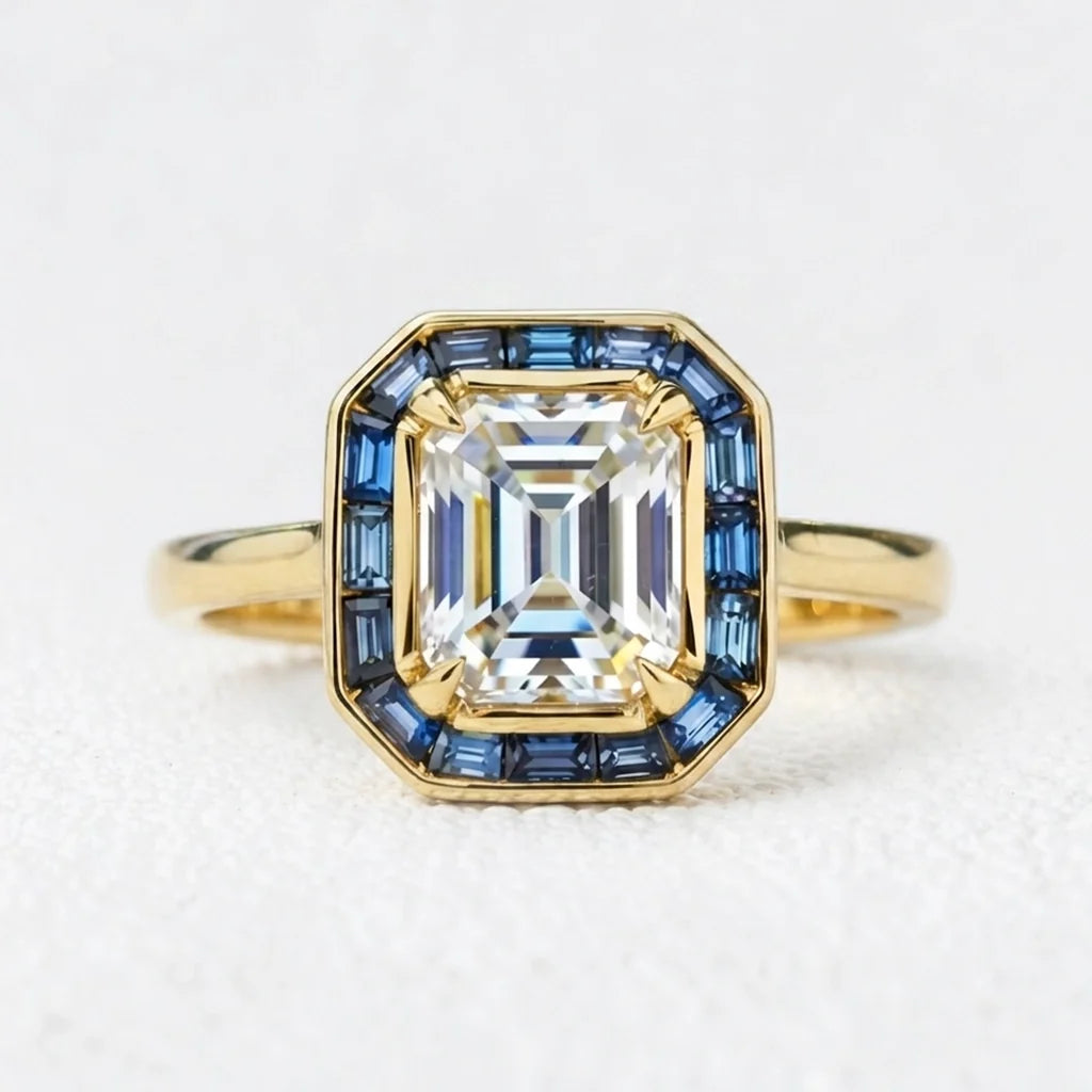 Celia’s Ode | 1CT Emerald Cut Diamond Engagement Ring with Sapphire Halo