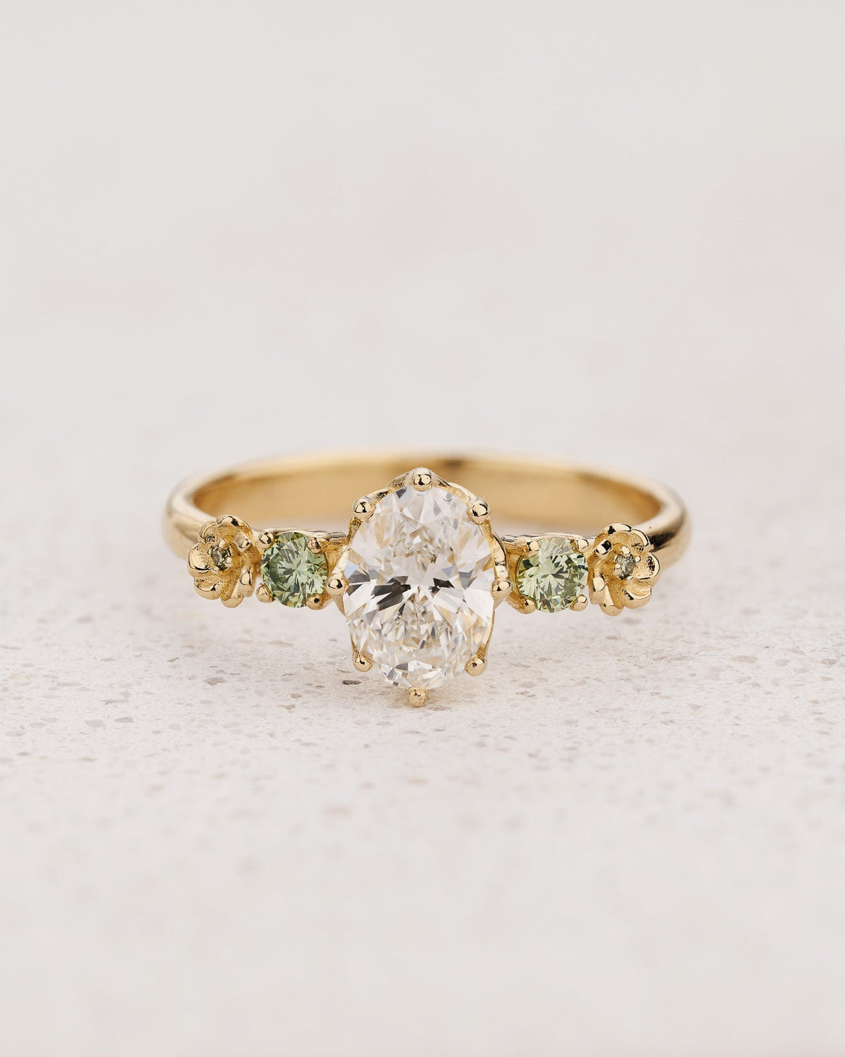 Flower-Inspired Engagement Ring with Oval Diamond and Green Diamond Accents / Fiorella