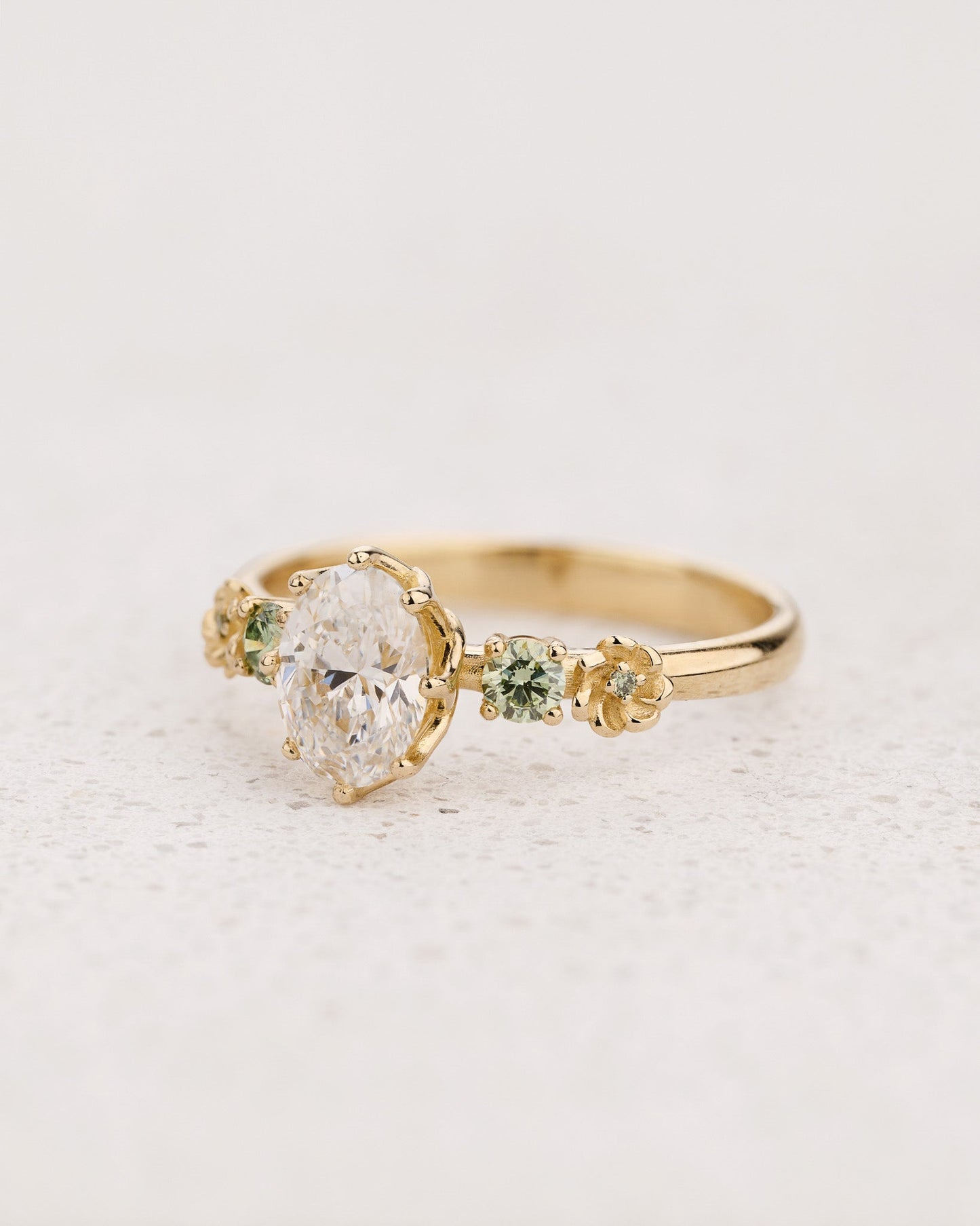 Flower-Inspired Engagement Ring with Oval Diamond and Green Diamond Accents / Fiorella