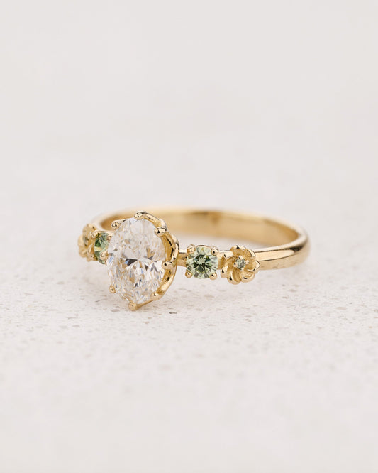 Flower-Inspired Engagement Ring with Oval Diamond and Green Diamond Accents / Fiorella