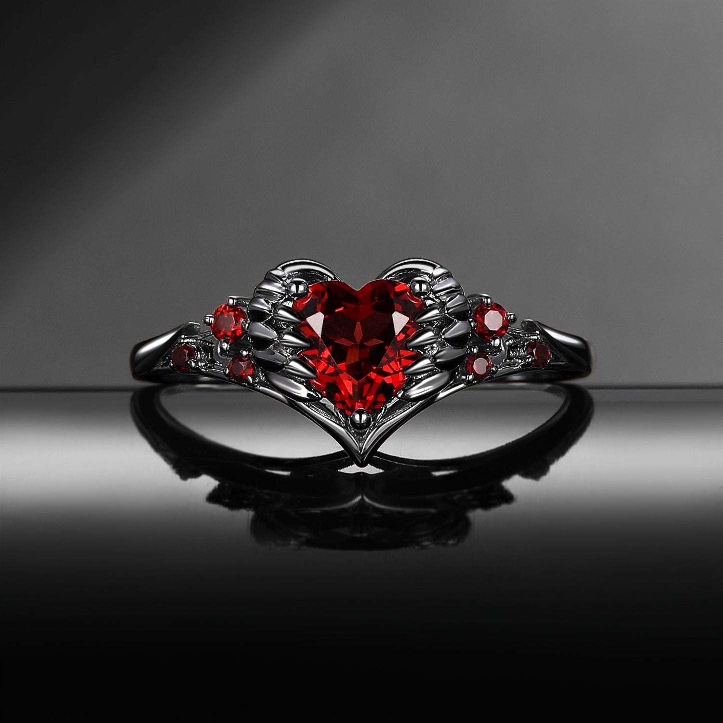 Heart & Sword 'Pierced Heart' – Gothic Garnet Engagement Ring with Angel Wing Detail