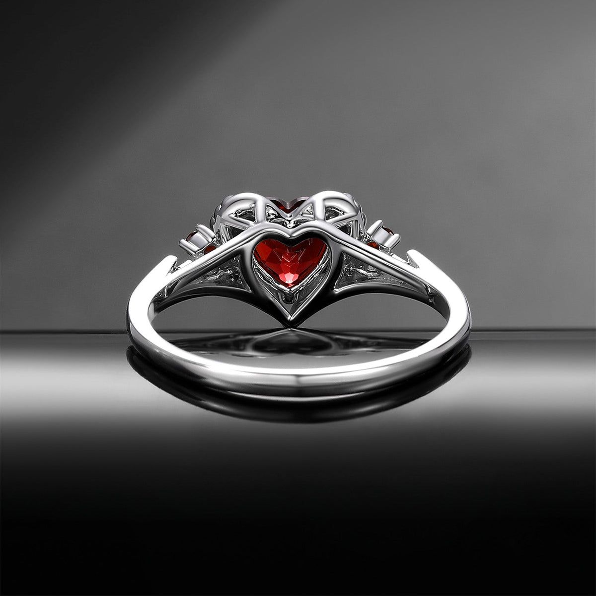 Heart & Sword 'Pierced Heart' – Gothic Garnet Engagement Ring with Angel Wing Detail