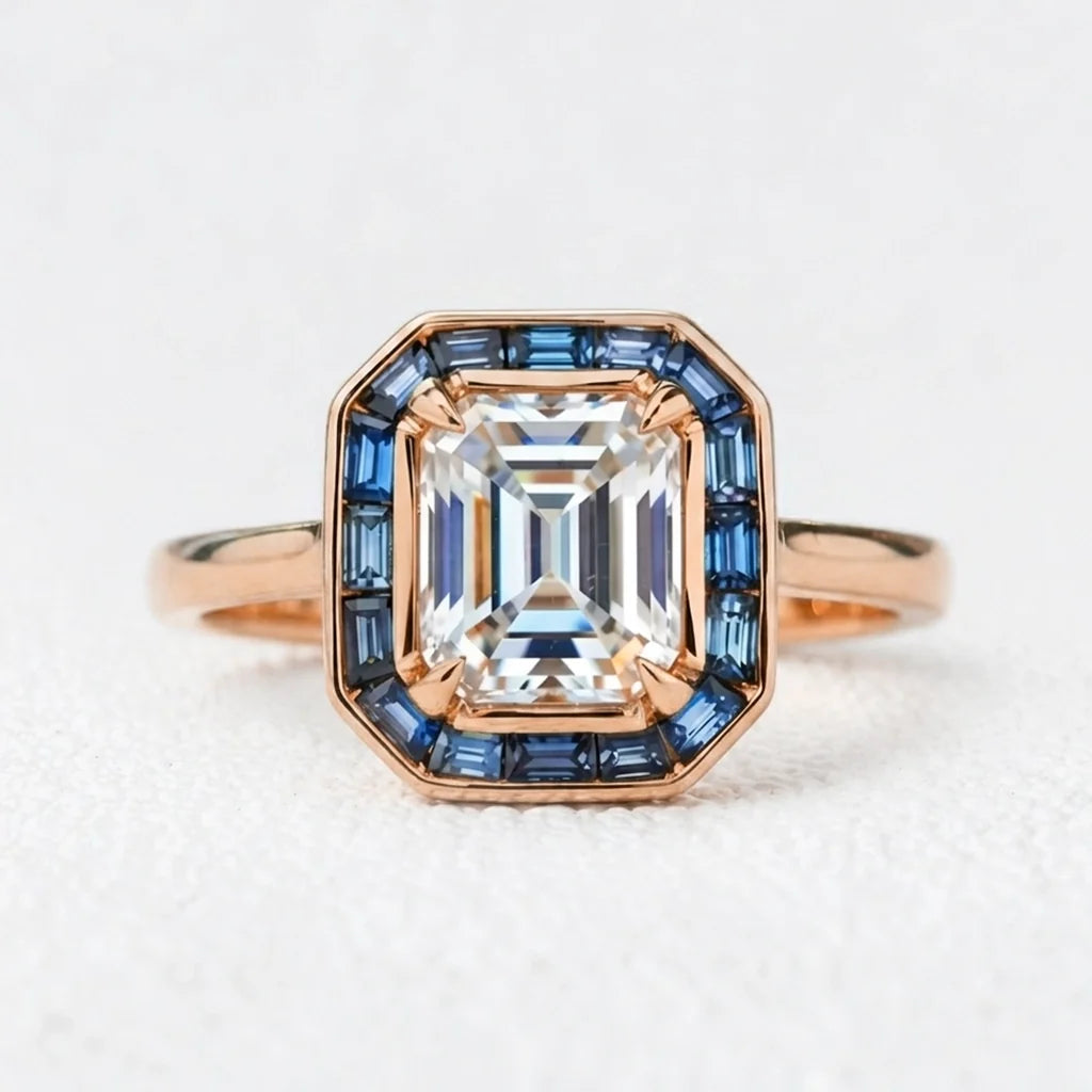 Celia’s Ode | 1CT Emerald Cut Diamond Engagement Ring with Sapphire Halo