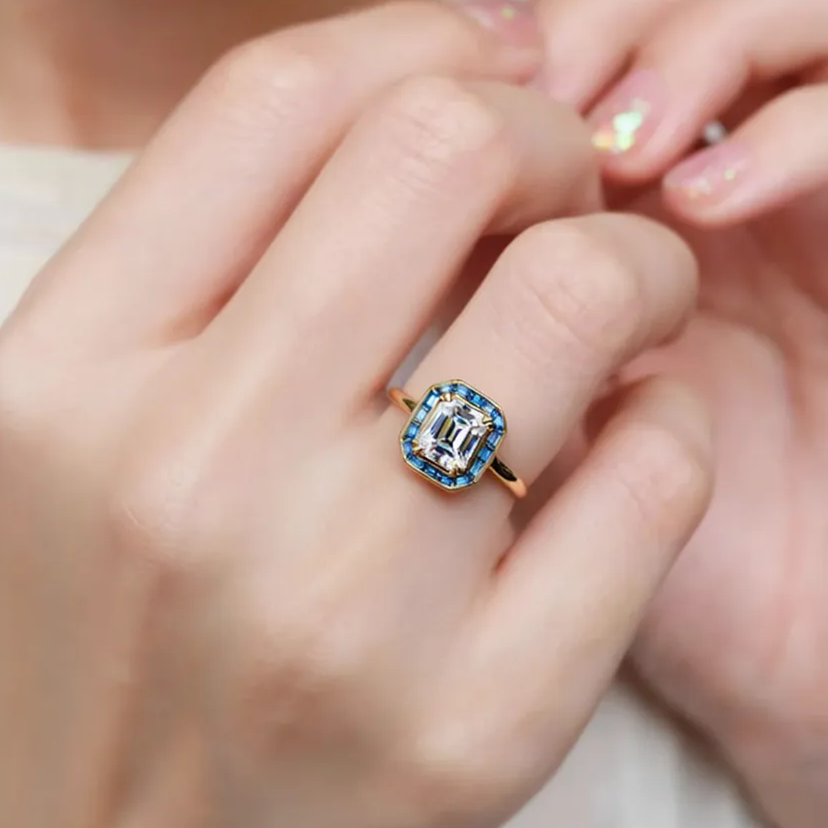 Celia’s Ode | 1CT Emerald Cut Diamond Engagement Ring with Sapphire Halo
