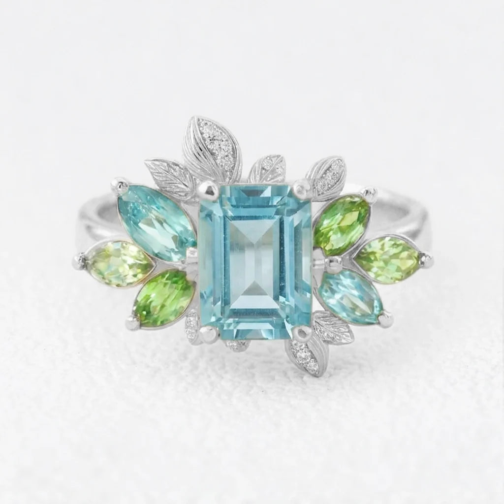 Celeste’s Bloom | Emerald Cut Blue Topaz Leafy Engagement Ring