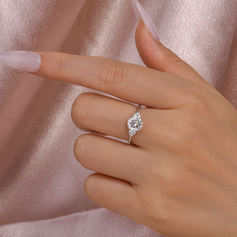Ornate Solarii Moissanite 1.2ct Round Cut 925 Sterling Silver Side Stone Engagement Ring