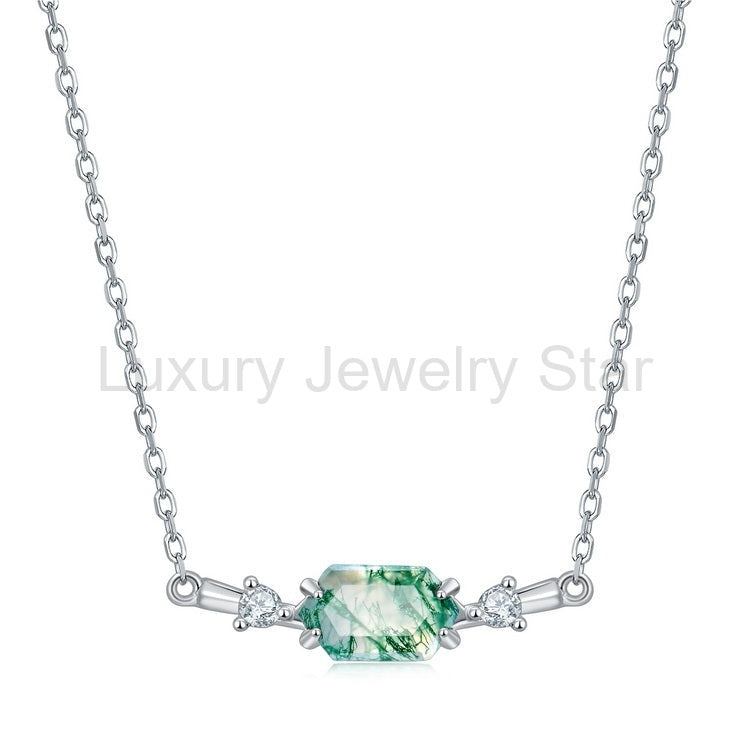Front view of a horizontal green hexagon centerpiece with two clear side accents and chain on a
