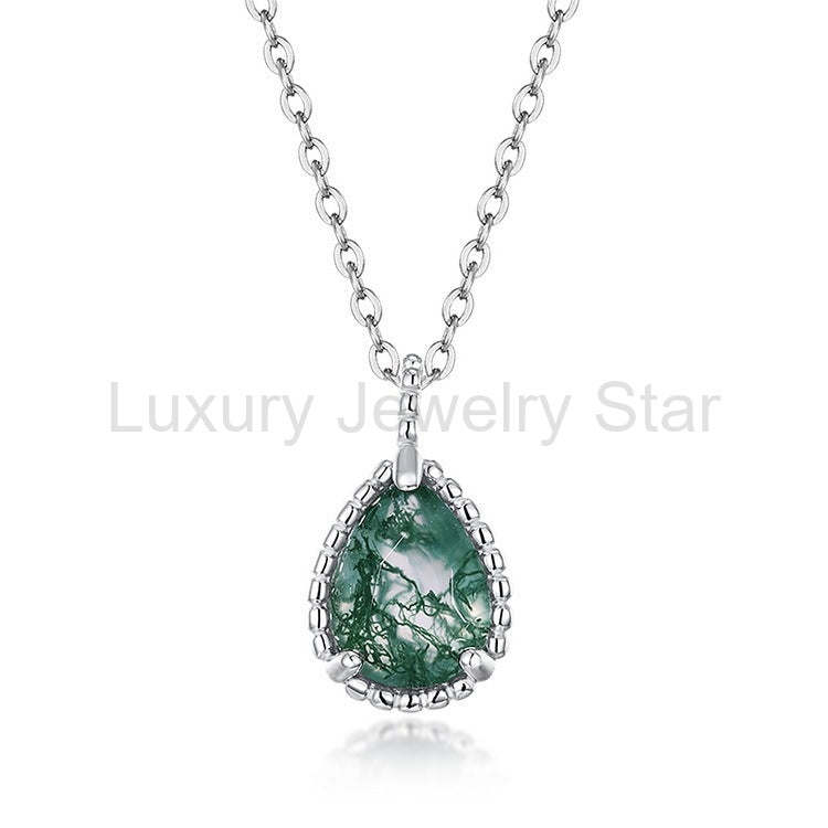 Front view of a pear-shaped green-patterned pendant with a silver-tone beaded border and chain on a