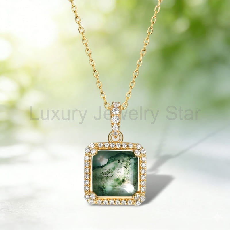 Square green-patterned pendant with clear halo accents, a gold-tone frame and chain against a