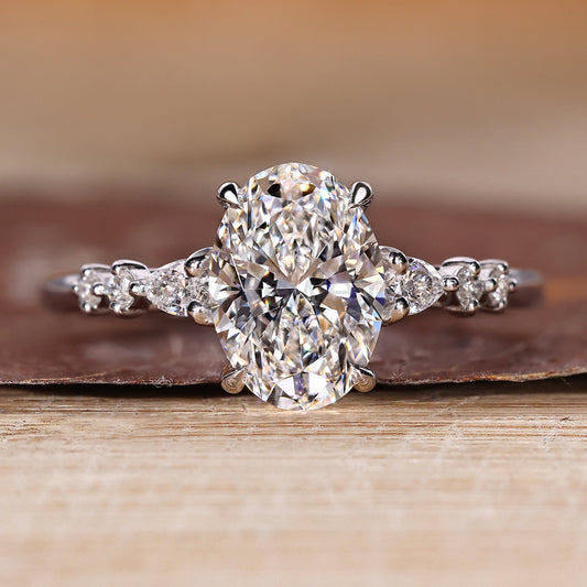 Oval Cut Diamond Ring with Pear and Round Side Stones