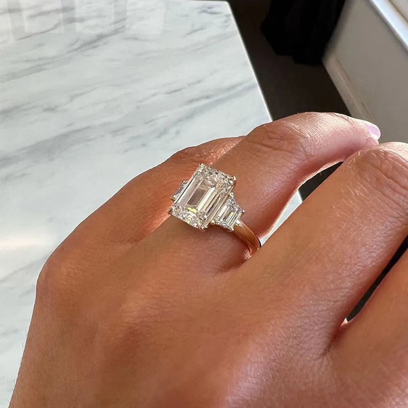 Lavish Emerald Cut 4.0ct Three Stone Engagement Ring In Sterling Silver