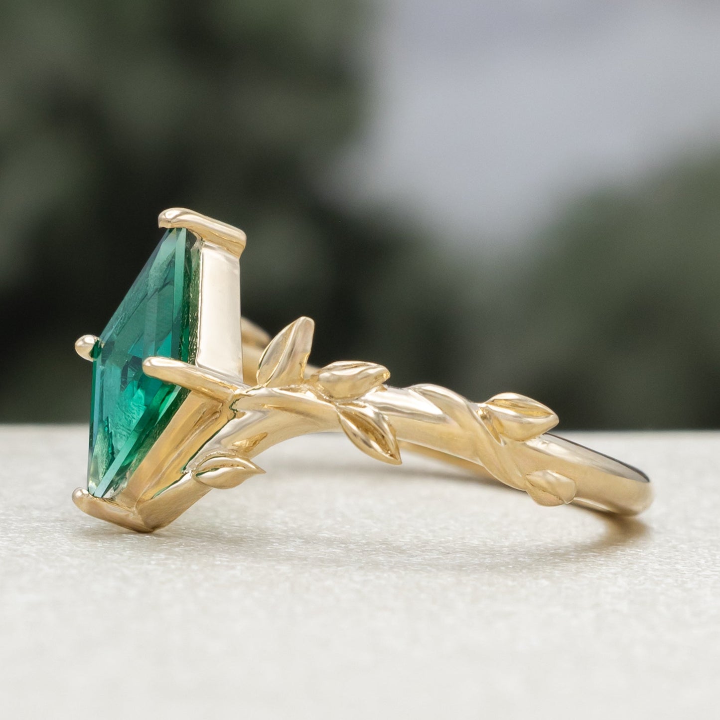 "Fae" - Solitaire Lozenge Cut Lab-Grown Emerald Engagement Ring On A Branch-Style Band