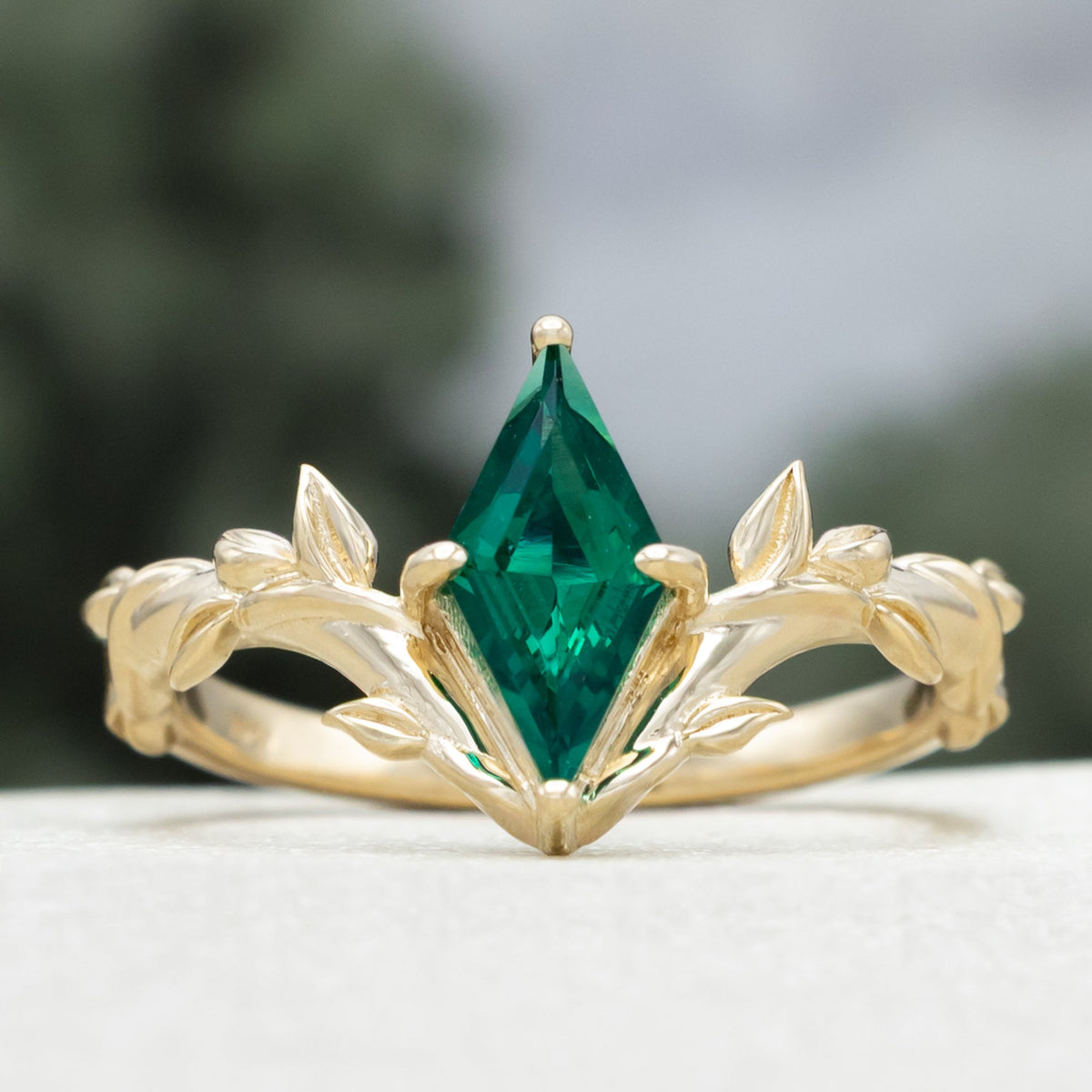 "Fae" - Solitaire Lozenge Cut Lab-Grown Emerald Engagement Ring On A Branch-Style Band