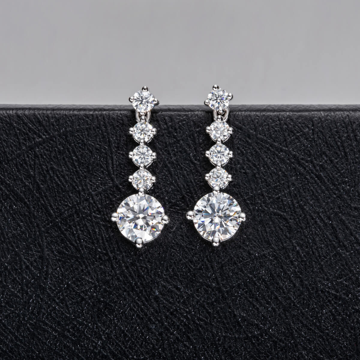 Graduated Linear Moissanite Drop Earrings In Sterling Silver