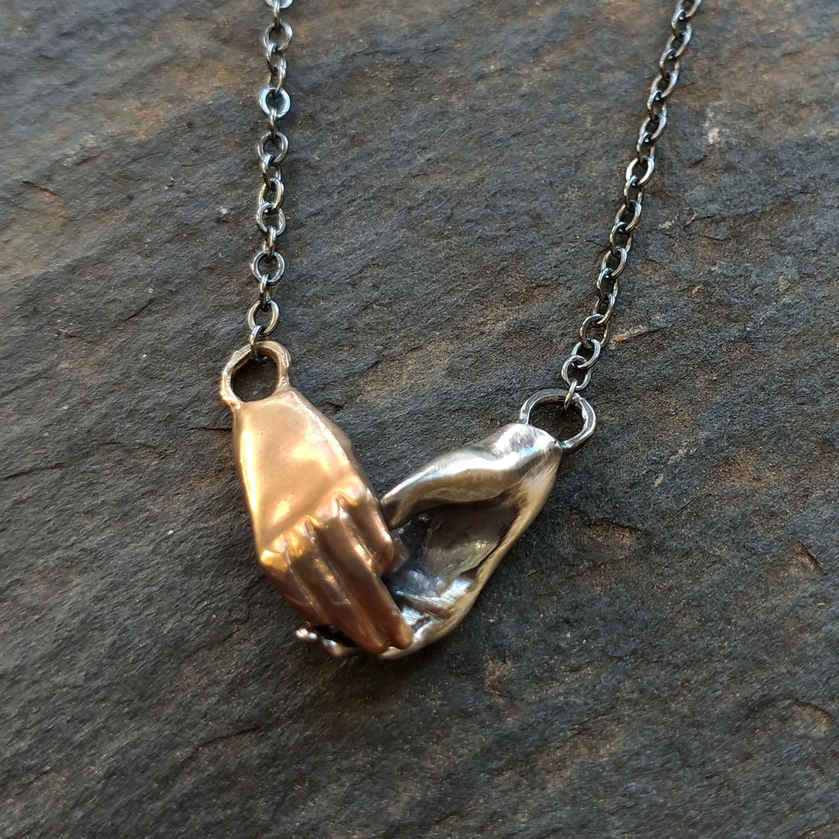 Bronze and Silver Holding Hands Necklace