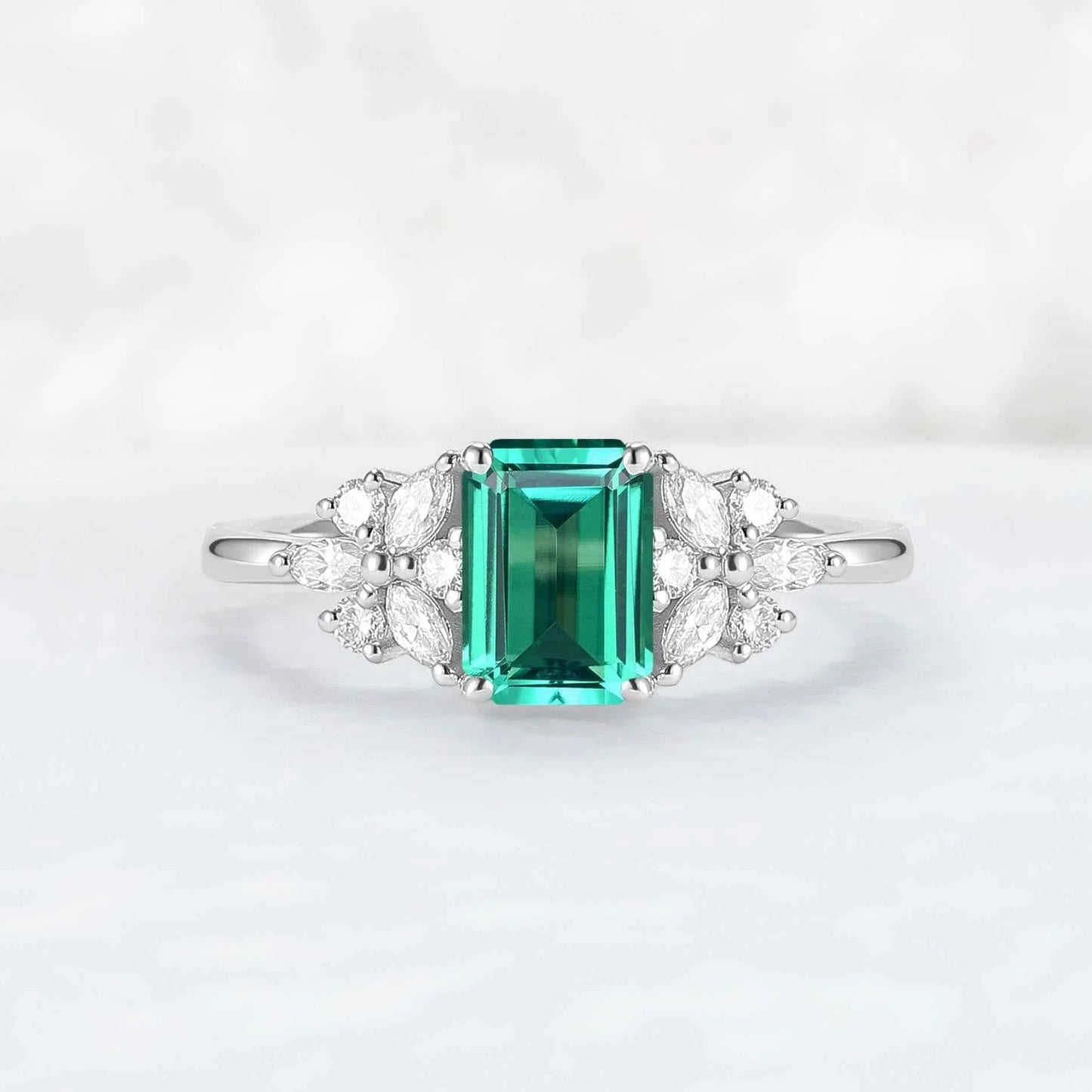 Nature Inspired Emerald Cut Emerald Ring with Petal Moissanite Side Stones