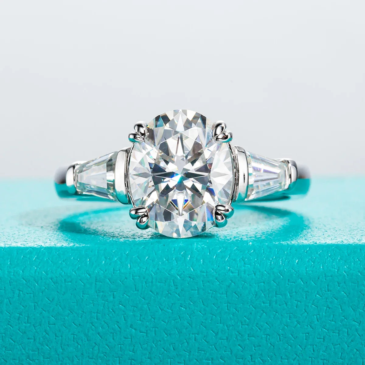 Three Stone Oval Moissanite And Tapered Baguette Engagement Ring