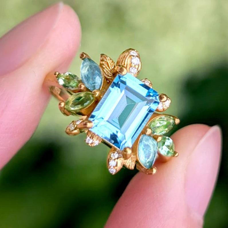 Celeste’s Bloom | Emerald Cut Blue Topaz Leafy Engagement Ring