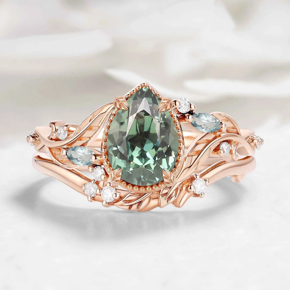 Nature-Inspired Leaf Vintage Bezel Pear Cut Green Sapphire Bridal Set
