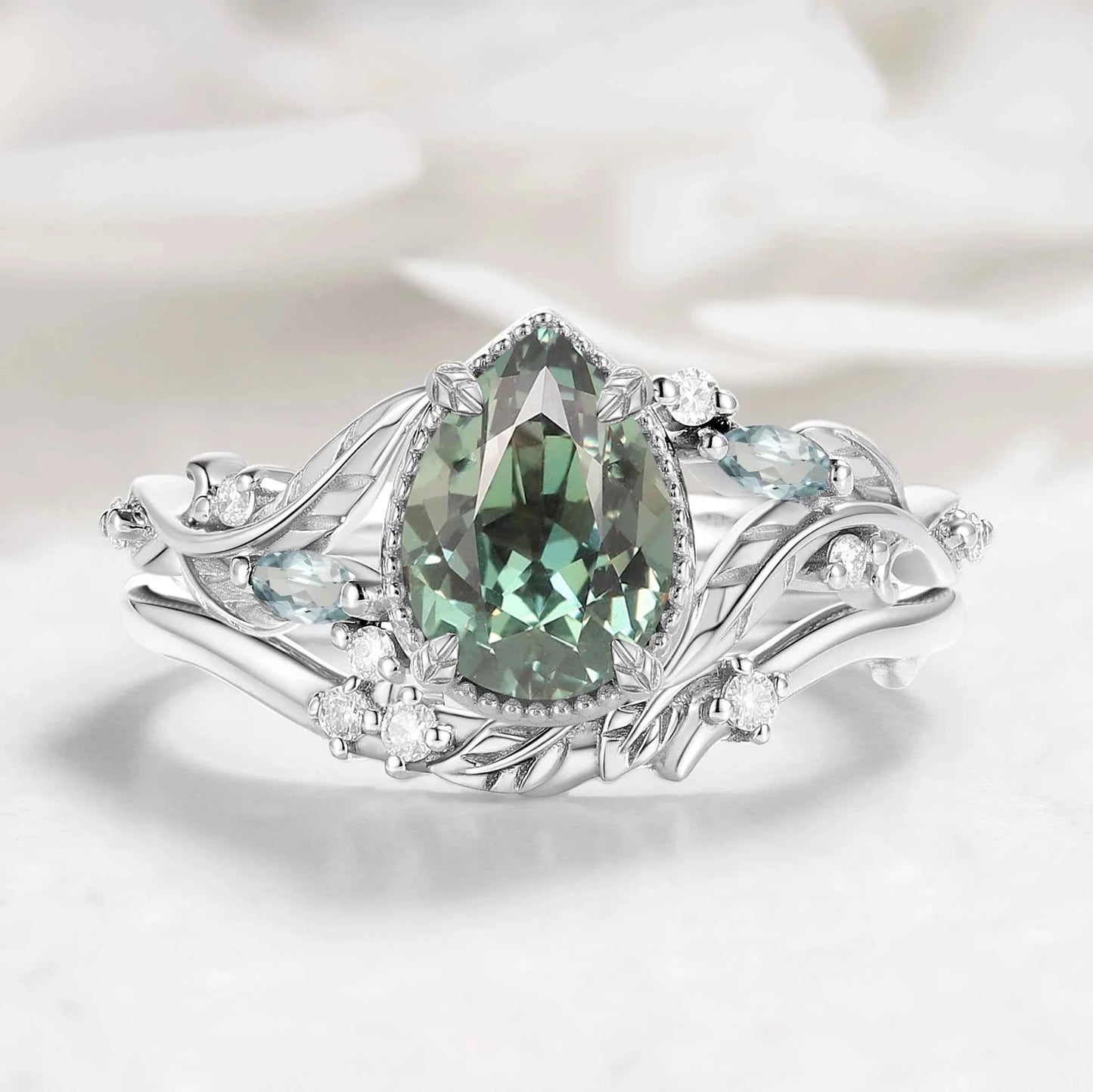 Nature-Inspired Leaf Vintage Bezel Pear Cut Green Sapphire Bridal Set