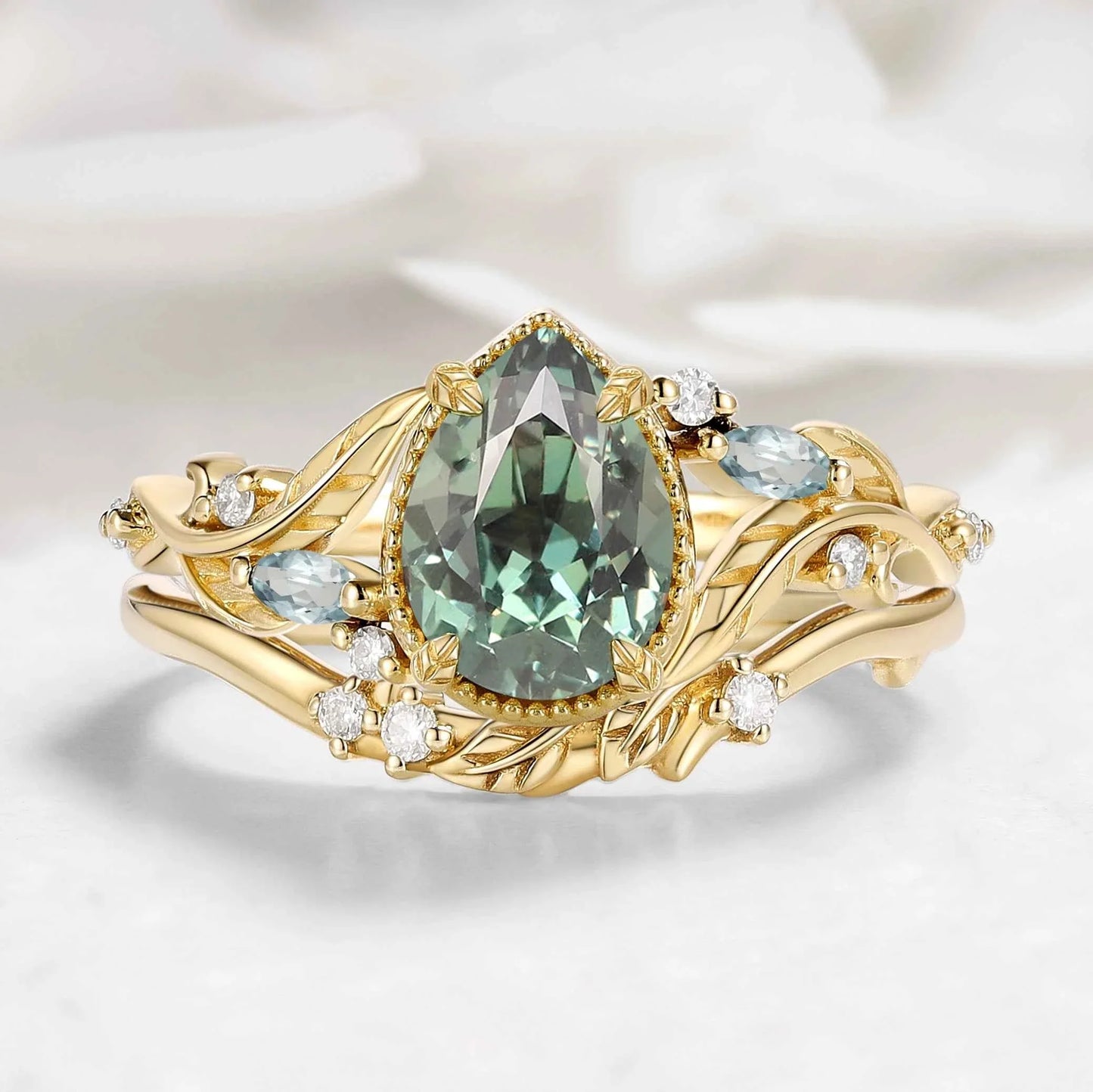 Nature-Inspired Leaf Vintage Bezel Pear Cut Green Sapphire Bridal Set