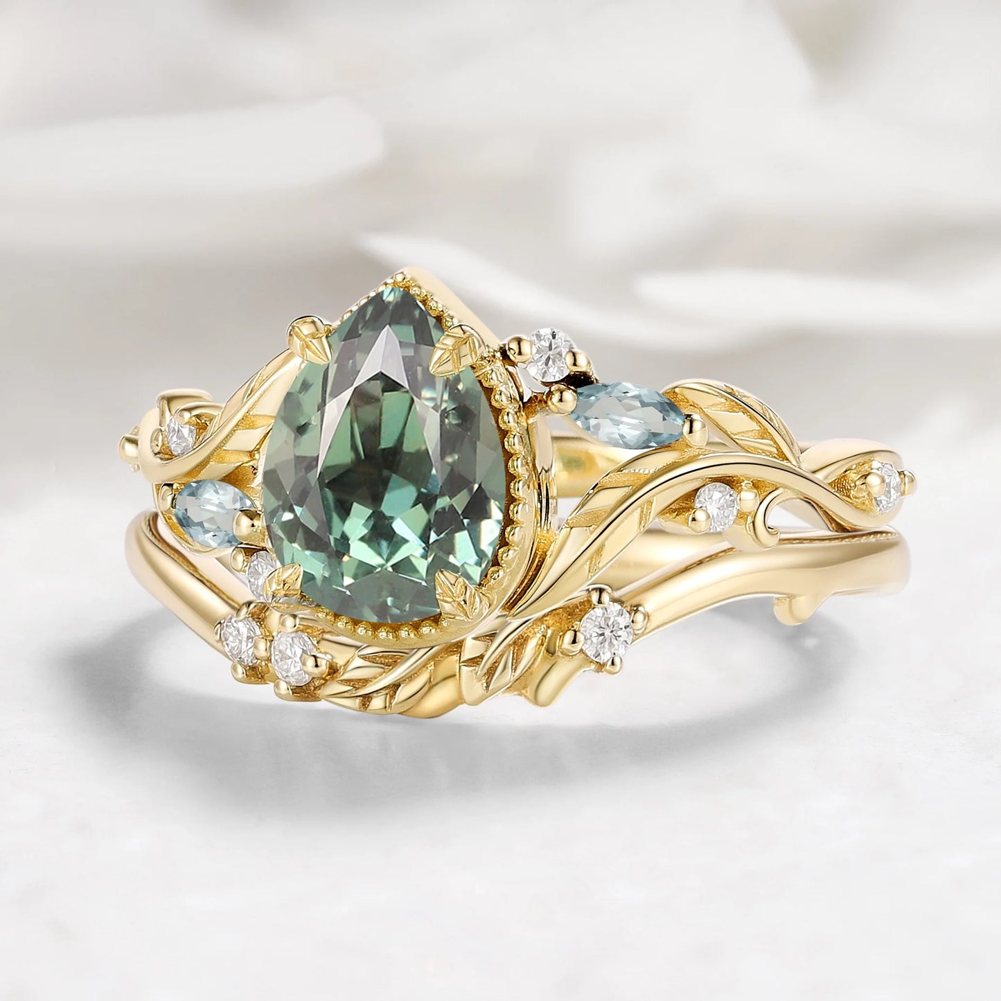 Nature-Inspired Leaf Vintage Bezel Pear Cut Green Sapphire Bridal Set