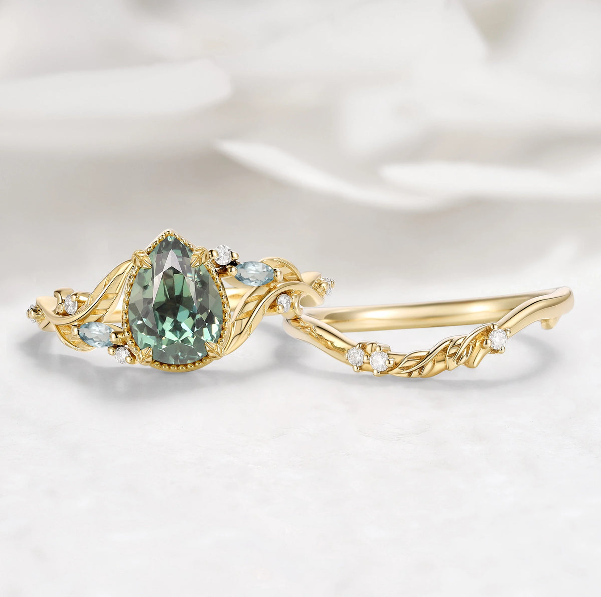 Nature-Inspired Leaf Vintage Bezel Pear Cut Green Sapphire Bridal Set