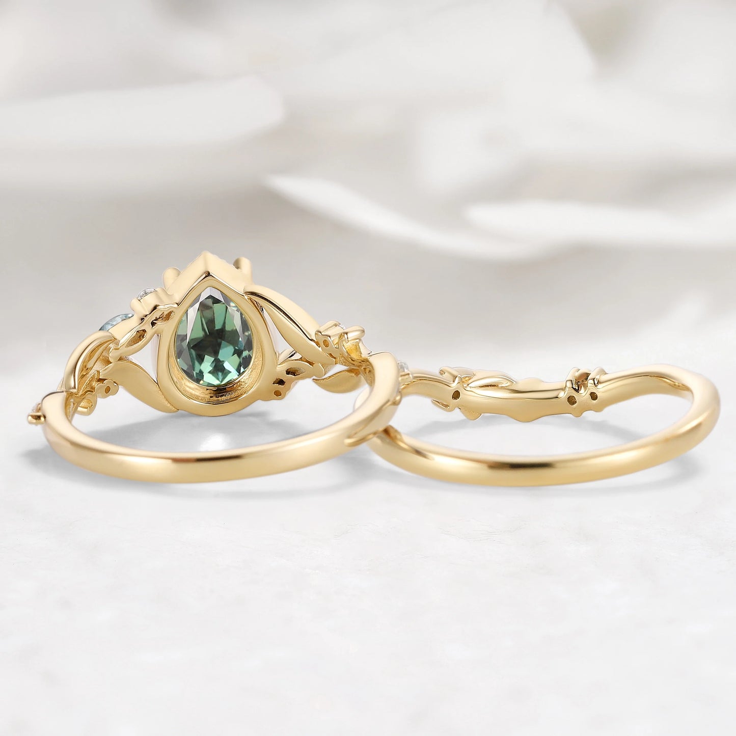 Nature-Inspired Leaf Vintage Bezel Pear Cut Green Sapphire Bridal Set