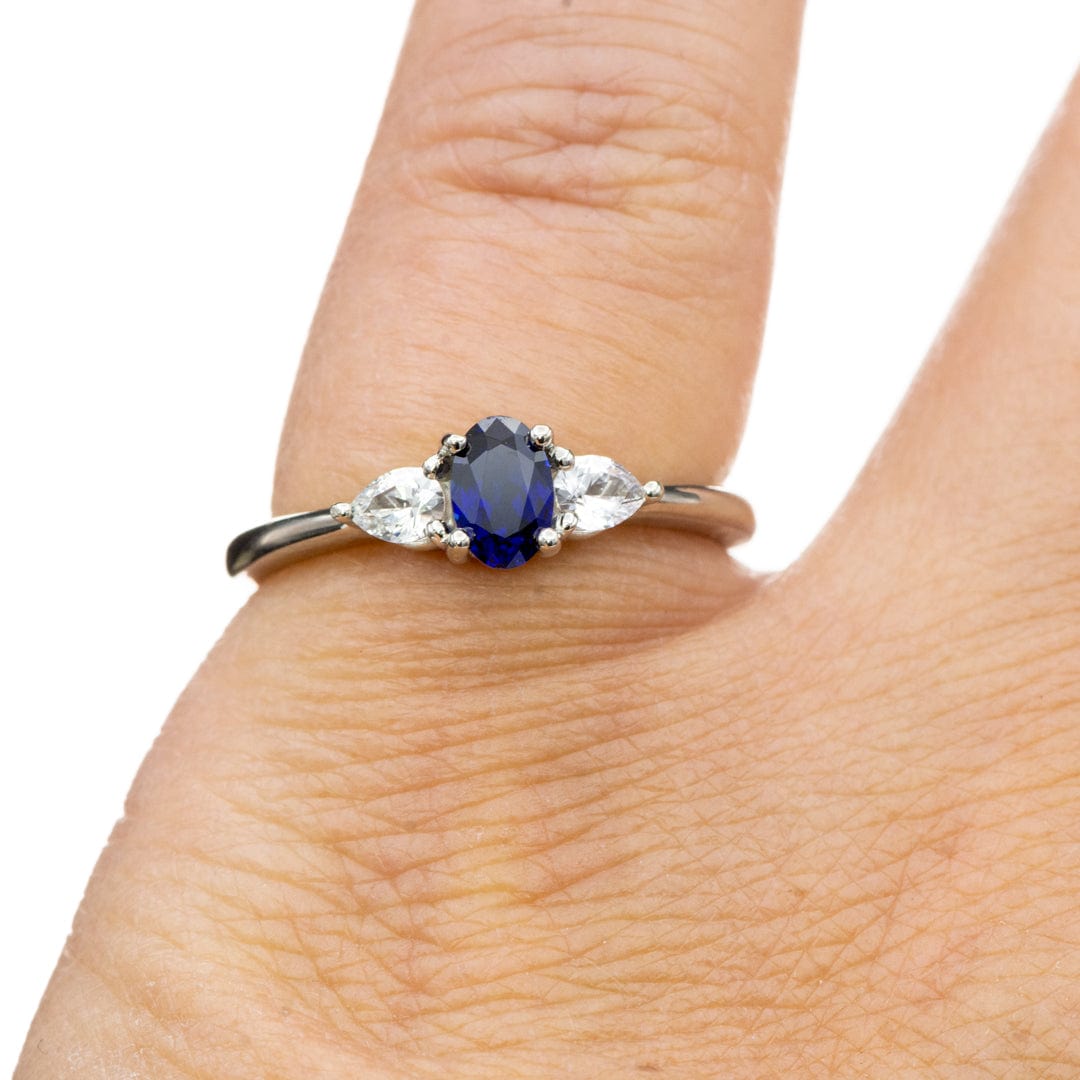 Tressa - Three Stone Prong Set Oval Lab Sapphire Engagement Ring with Pear-shaped White Sapphire Accents