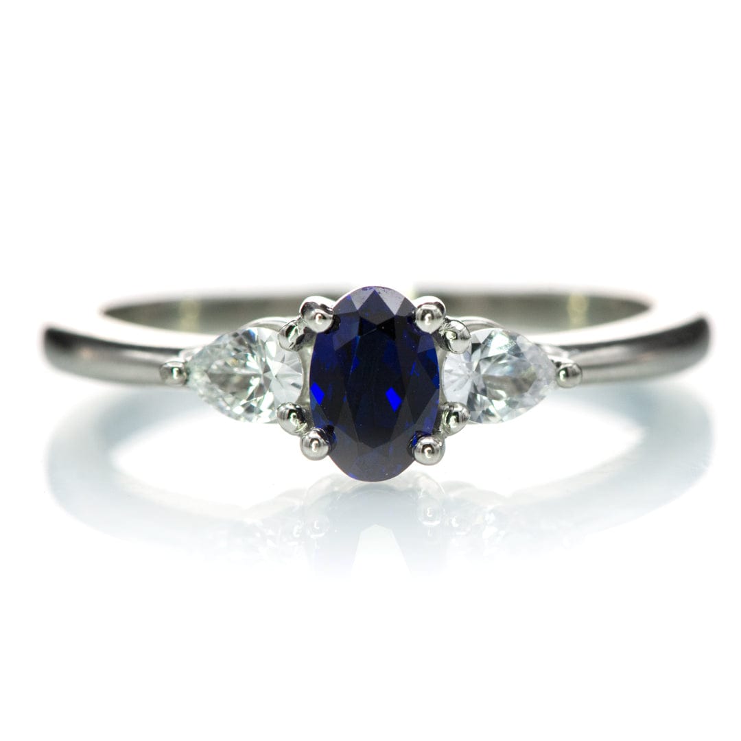 Tressa - Three Stone Prong Set Oval Lab Sapphire Engagement Ring with Pear-shaped White Sapphire Accents