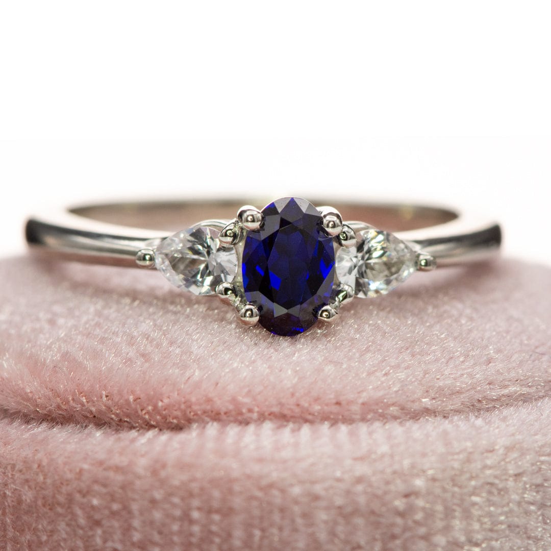 Tressa - Three Stone Prong Set Oval Lab Sapphire Engagement Ring with Pear-shaped White Sapphire Accents